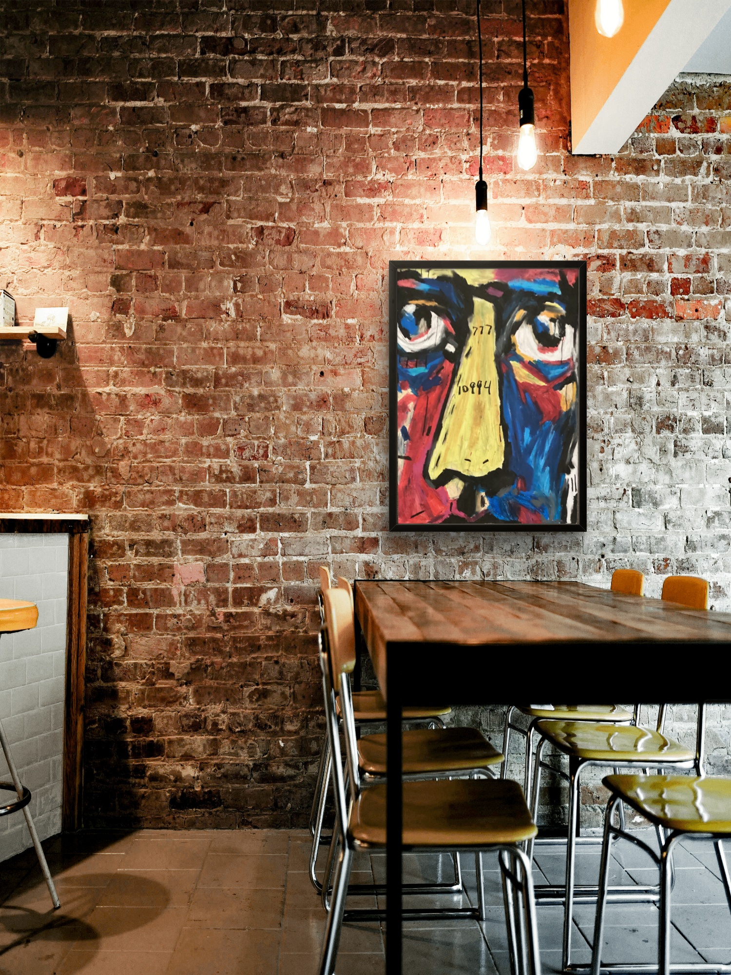 An original Numbered Figures face hanging framed on a brick wall
